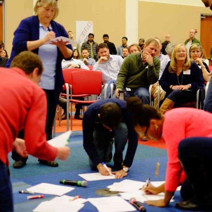 An Open Space session: participants writing proposals on the floor